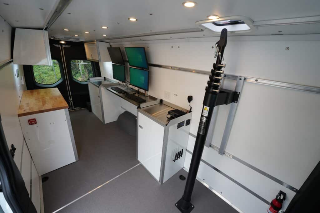 The inside of a sprinter MCC with mast, cabinets and computers